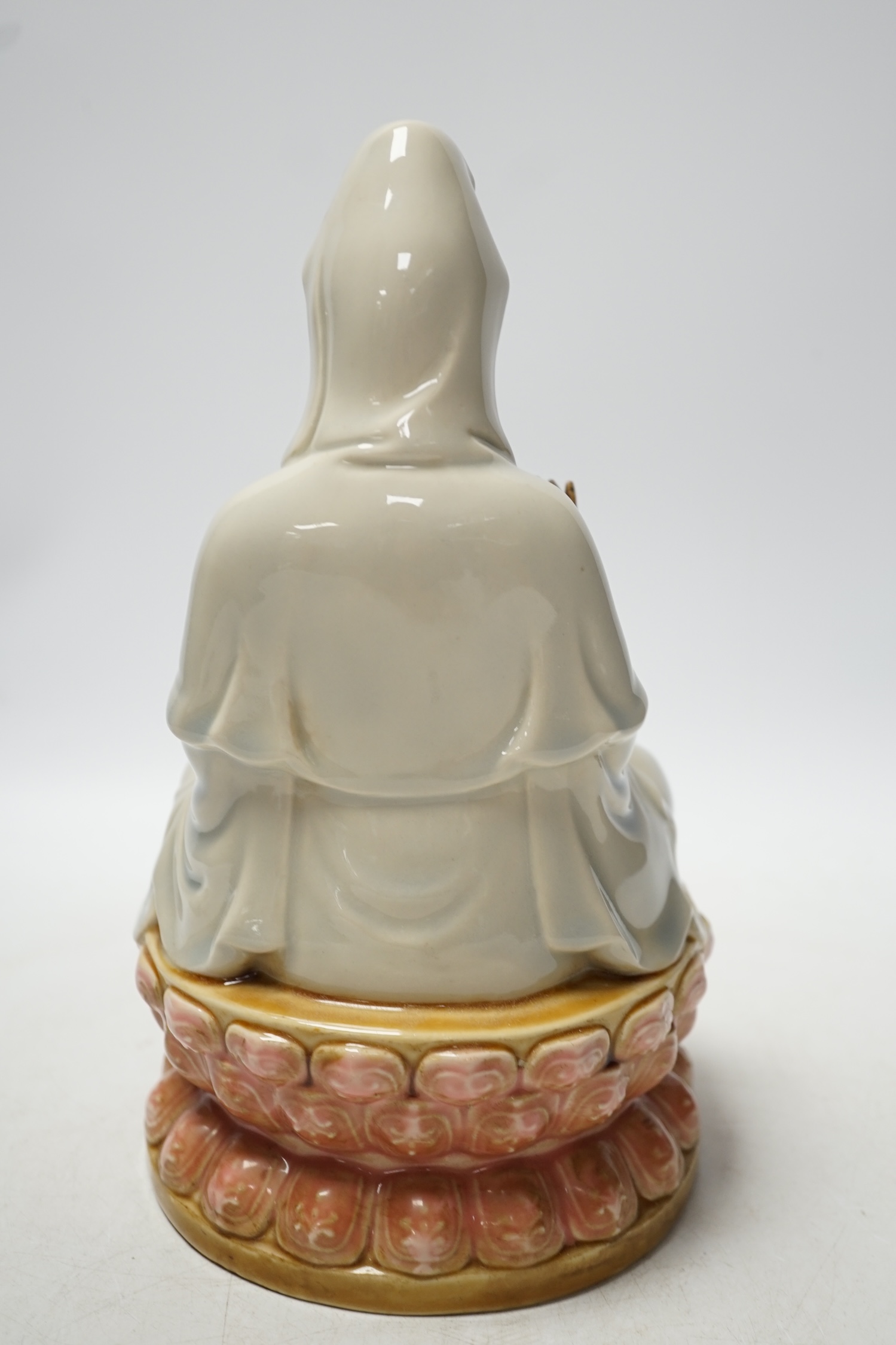 A Chinese enamelled porcelain figure of Guanyin, 19th century, 25cm high. Condition - fair